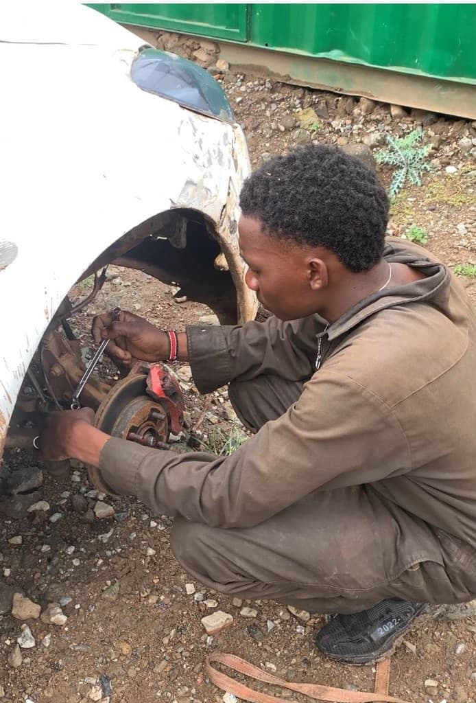 Top Mechanic technician working on a vehicle wheel on site